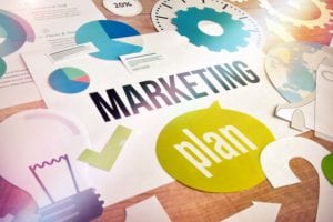 overhead view of graphs, graphics and words marketing plan