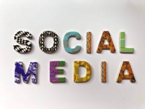 The words social media spelled out using multicolor designed letter magnets